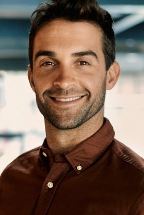 Smiling man in dark brown button up shirt