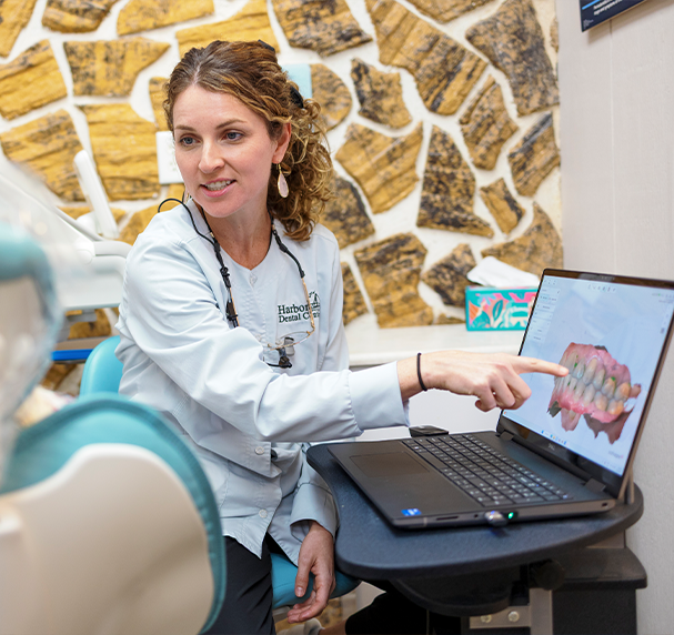 Dentist showing digital render of teeth to patient