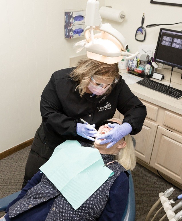 Dentist examining the mouth of a patient