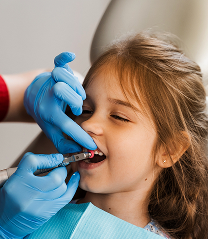Little girl having her teeth cleaned