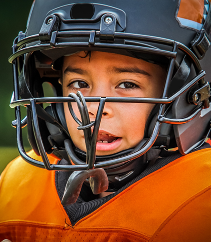 Little boy with football helmet and mouthguard