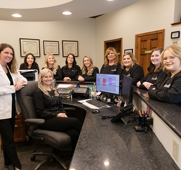 Cambridge dental team gathered at reception desk