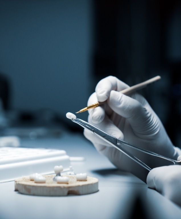 Dental ceramist designing a dental crown in Cambridge