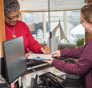 Team member showing patient form on a clipboard