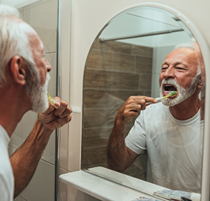 Older man brushing his teeth
