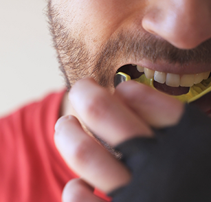 Man putting in a mouthguard