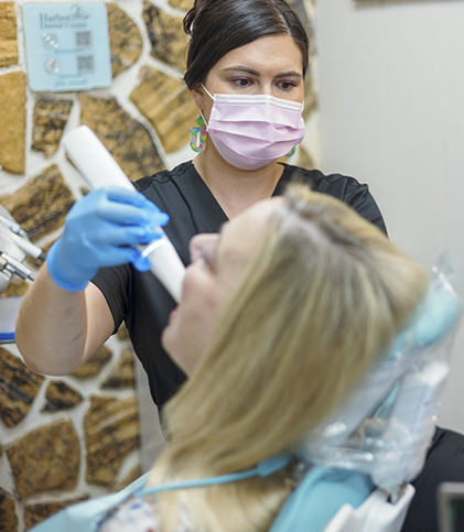 Dental team member scanning patient's teeth