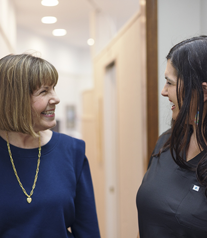 Female patient talking to female dental team member