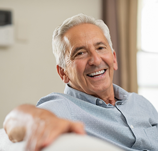 Man sitting on couch and smiling