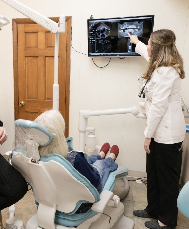 Doctor Todd showing a dental patient x rays of their teeth