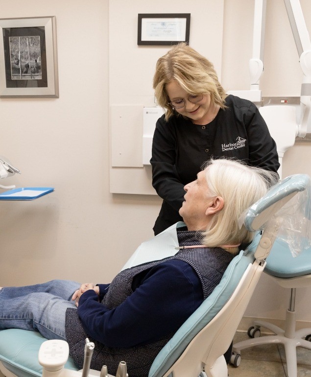 Emergency dentist in Cambridge talking to a patient in the dental chair