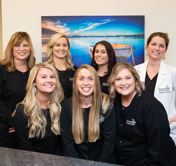 Dental team gathered and smiling