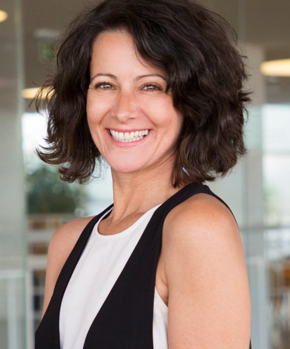 Smiling woman in black and white sleeveless blouse