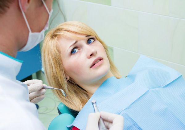 Woman afraid in the dental chair