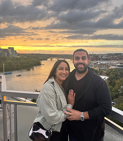 Dr. Bhatt with her husband in front of a body of water