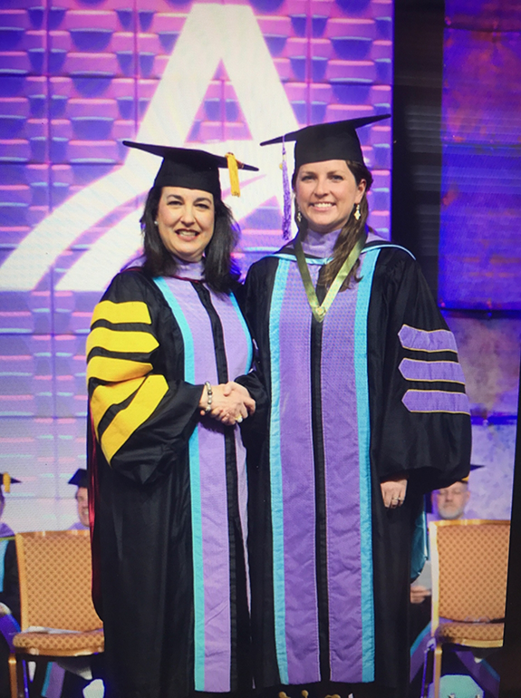 Dr. Todd shaking hands with professor during graduation