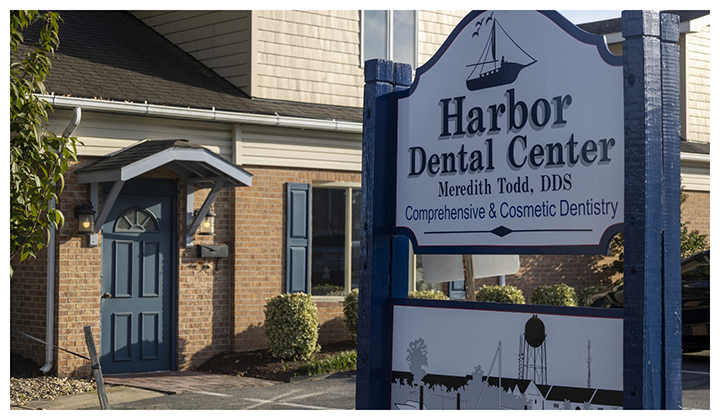 Sign for Harbor Dental Center in front of dental practice