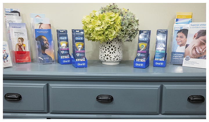 Brochures and flowers on top of a desk