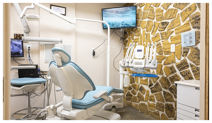 Close up of dental treatment chair facing wall with stones