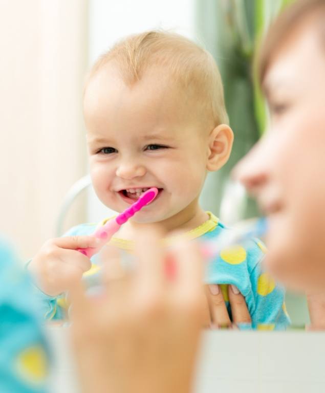 Baby holding a toothbrush