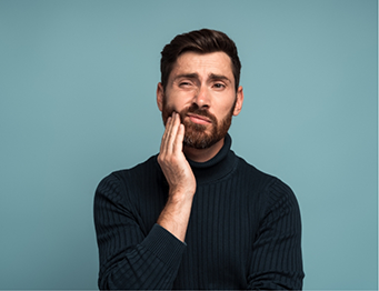 Man with beard rubbing his jaw