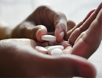 Placing pills in palm of hand