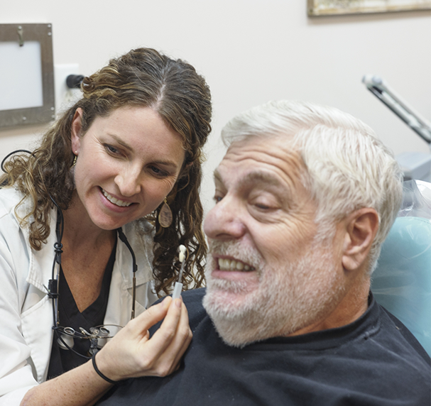 Showing dental restoration to male patient