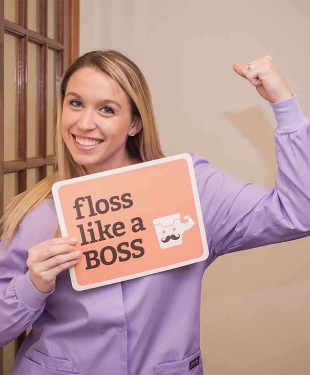 Jackie holding that says floss like a boss