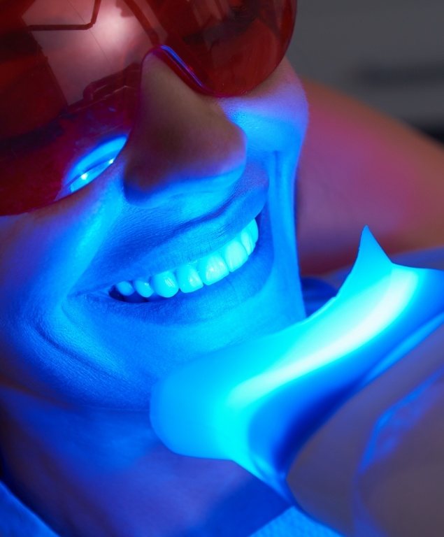 Woman in dental chair receiving professional teeth whitening in Cambridge