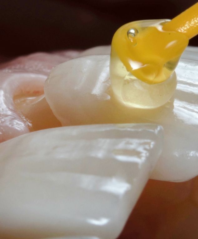 Close up of bonding liquid being applied to a veneer