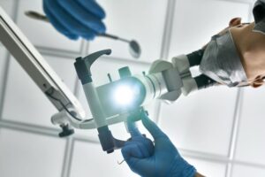 Dentist using microscope to work on patient