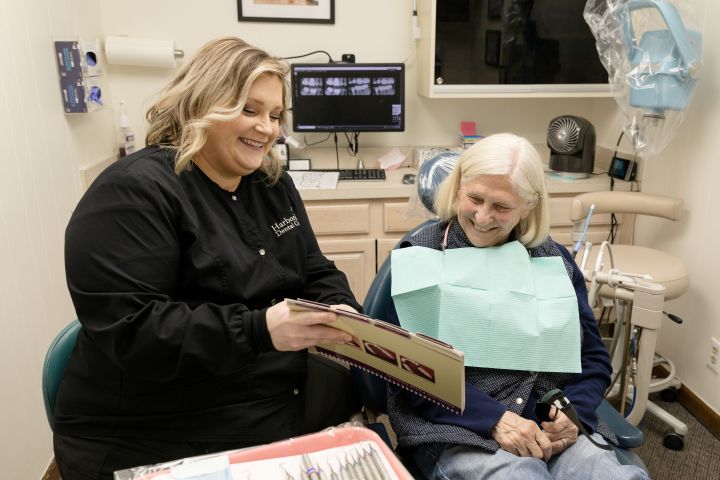 A dentist sharing X-rays with a patient.