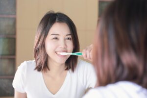 A young woman brushing her teeth